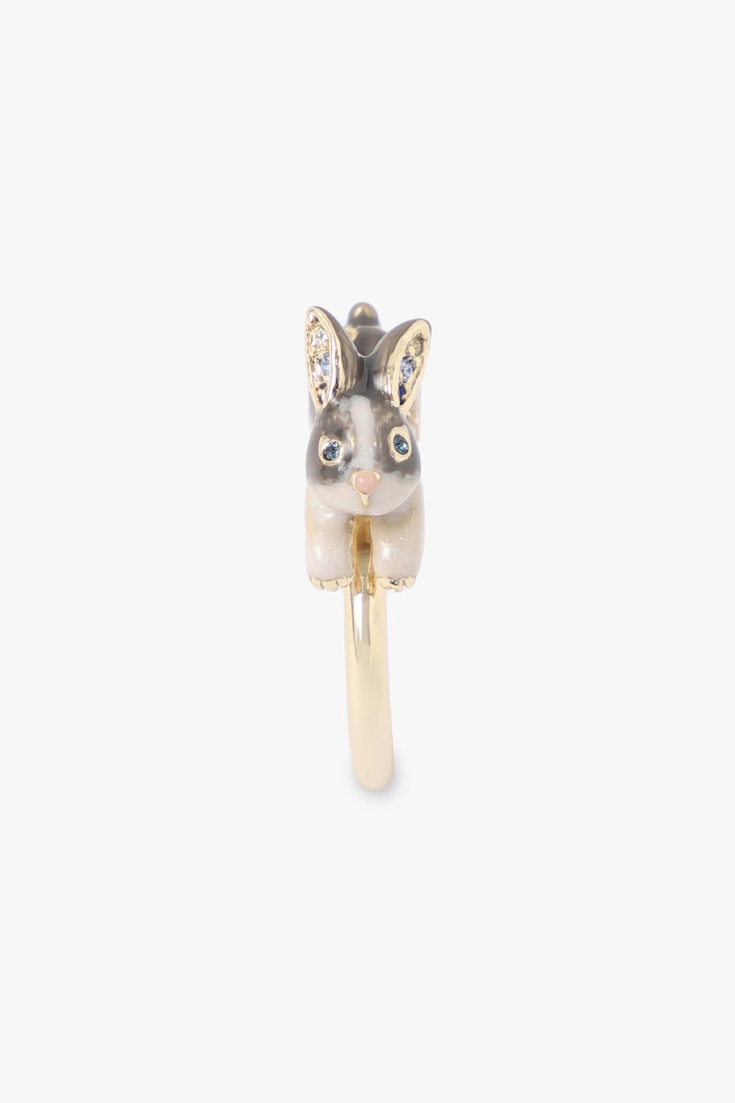 Grey Rabbit with blue eyes, golden on ears, paw, a pink nose, Running on a golden metal ring 