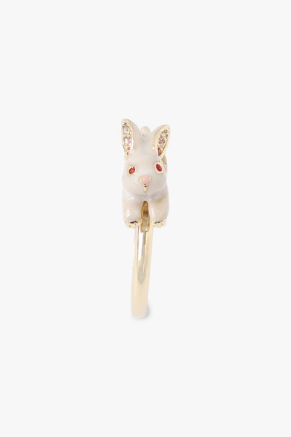 White Rabbit with red eyes, golden on ears, paw, a pink nose, Running on a golden metal ring 