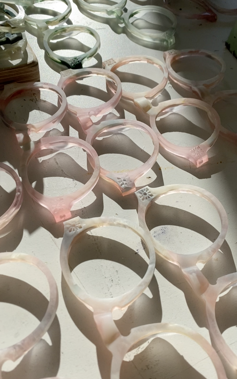 Round Sunglasses, pink and green frame eyeglasses frames at the factory before lens assembly