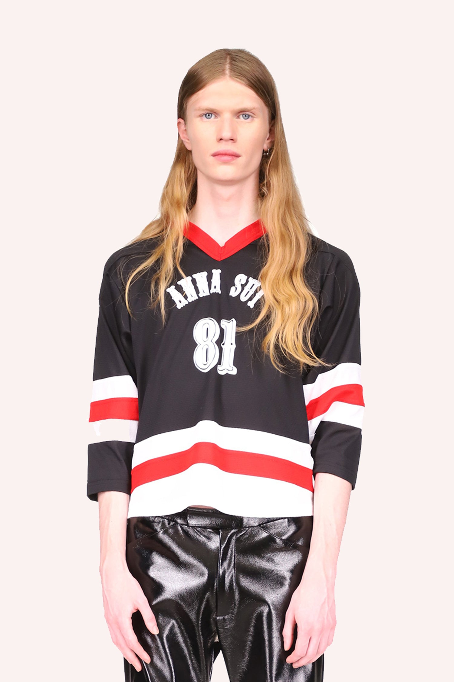 Jersey, mid arms sleeves, red v-collar, black top with Anna Sui and 81 in white, then stripes of white-red-white