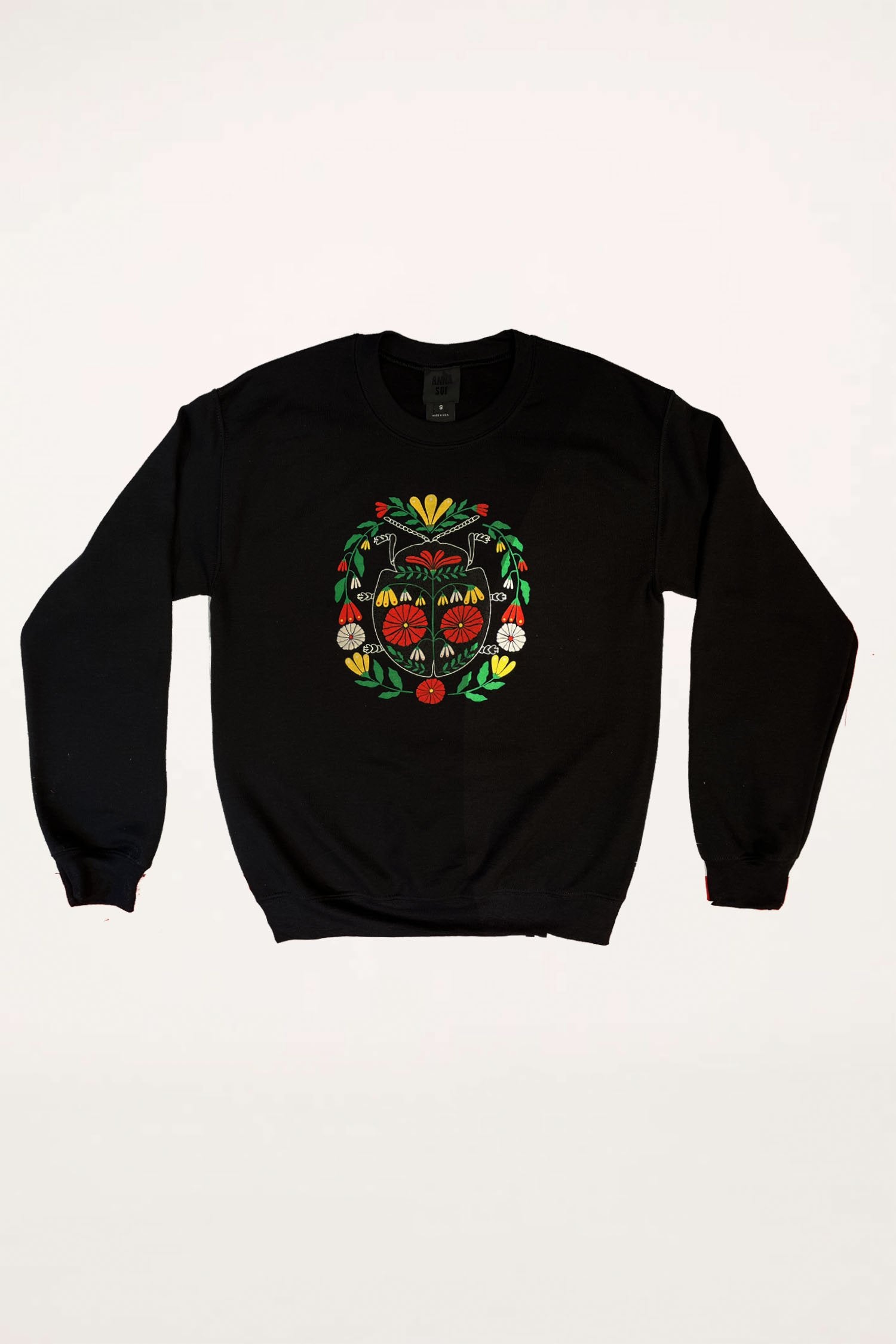 Beetle Sweatshirt Red, is black long sleeves, a large round floral design in red and green at center 