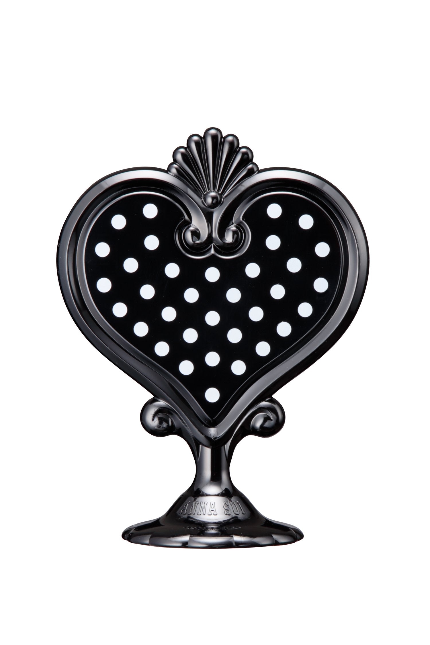 Black Stand Mirror in a heart-shaped with white dots in it on one side, mirror on the other, on a stand with Anna branding