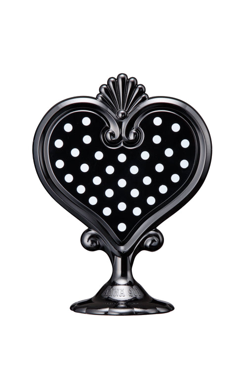 Black Stand Mirror in a hart-shaped with white dots in it on one side, mirror on the other, on a stand with Anna branding