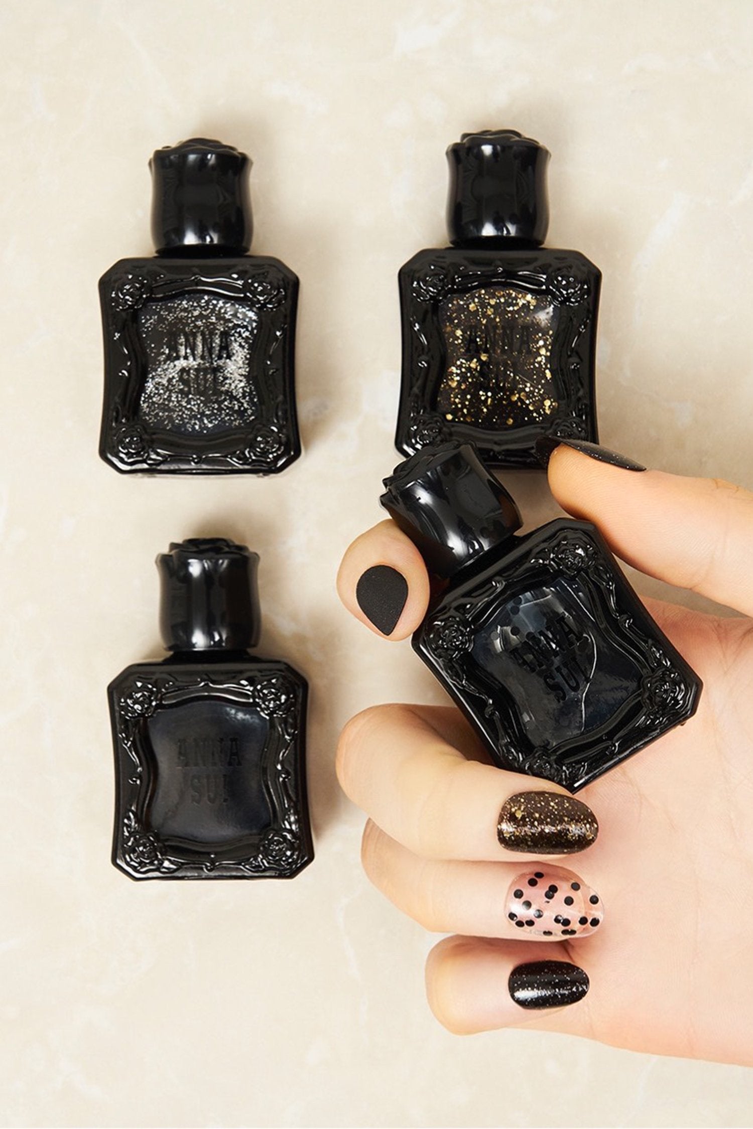Inspired by the fragrance 4 bottles, black container with raised rose pattern, Anna Sui on dark color.