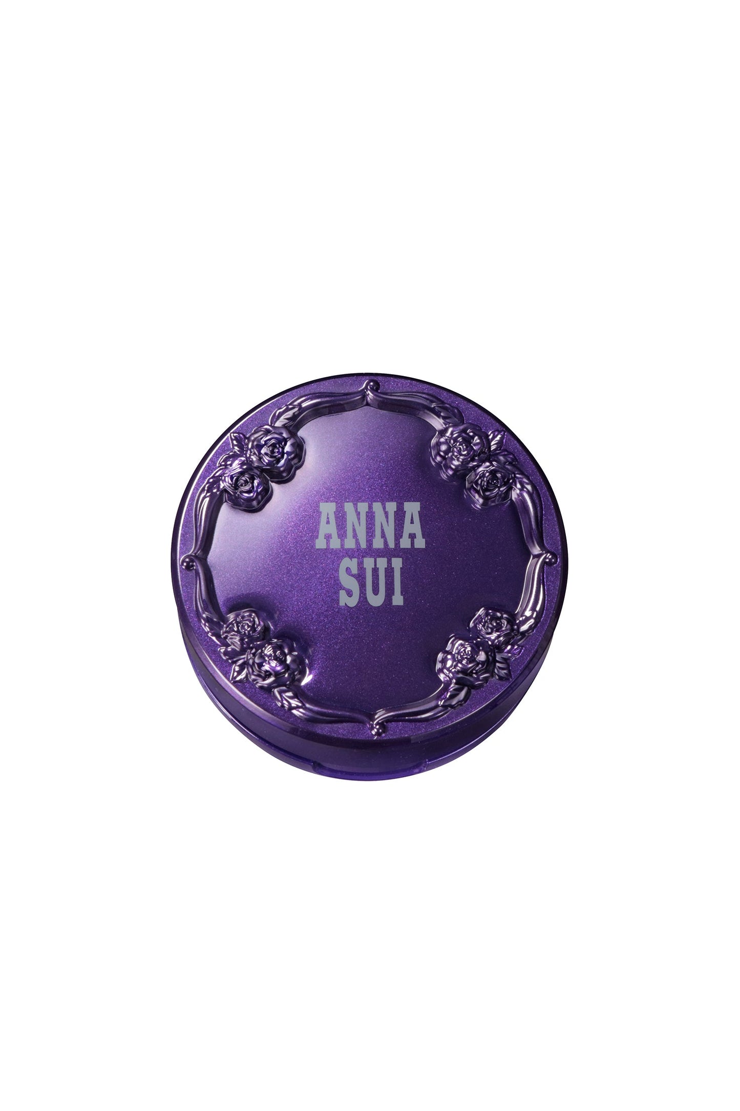 Contenitore rotondo di colore viola, sul coperchio un motivo a rose in rilievo e l'etichetta Anna Sui.