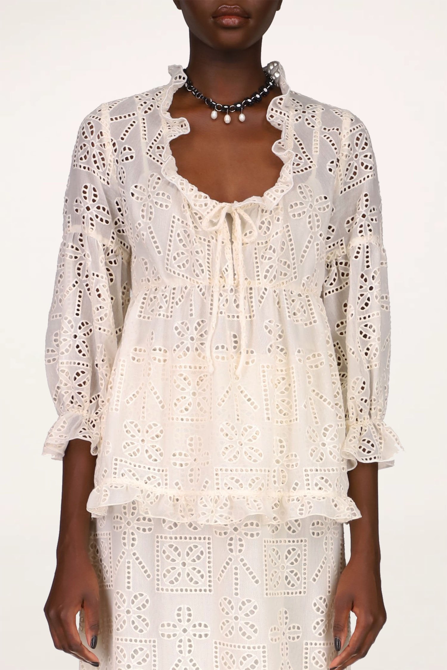 Aesthetic Eyelet Top Cream Stylized flowers with cutouts, and dotted cutouts lines