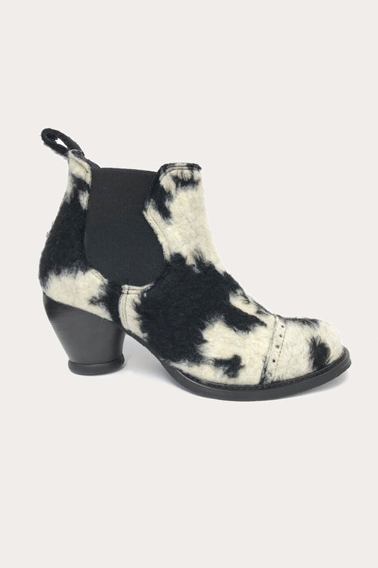 Faux Cowhide Chelsea Boot, mini boot, high heel, black/white fir, side elastic, and strap on the back 