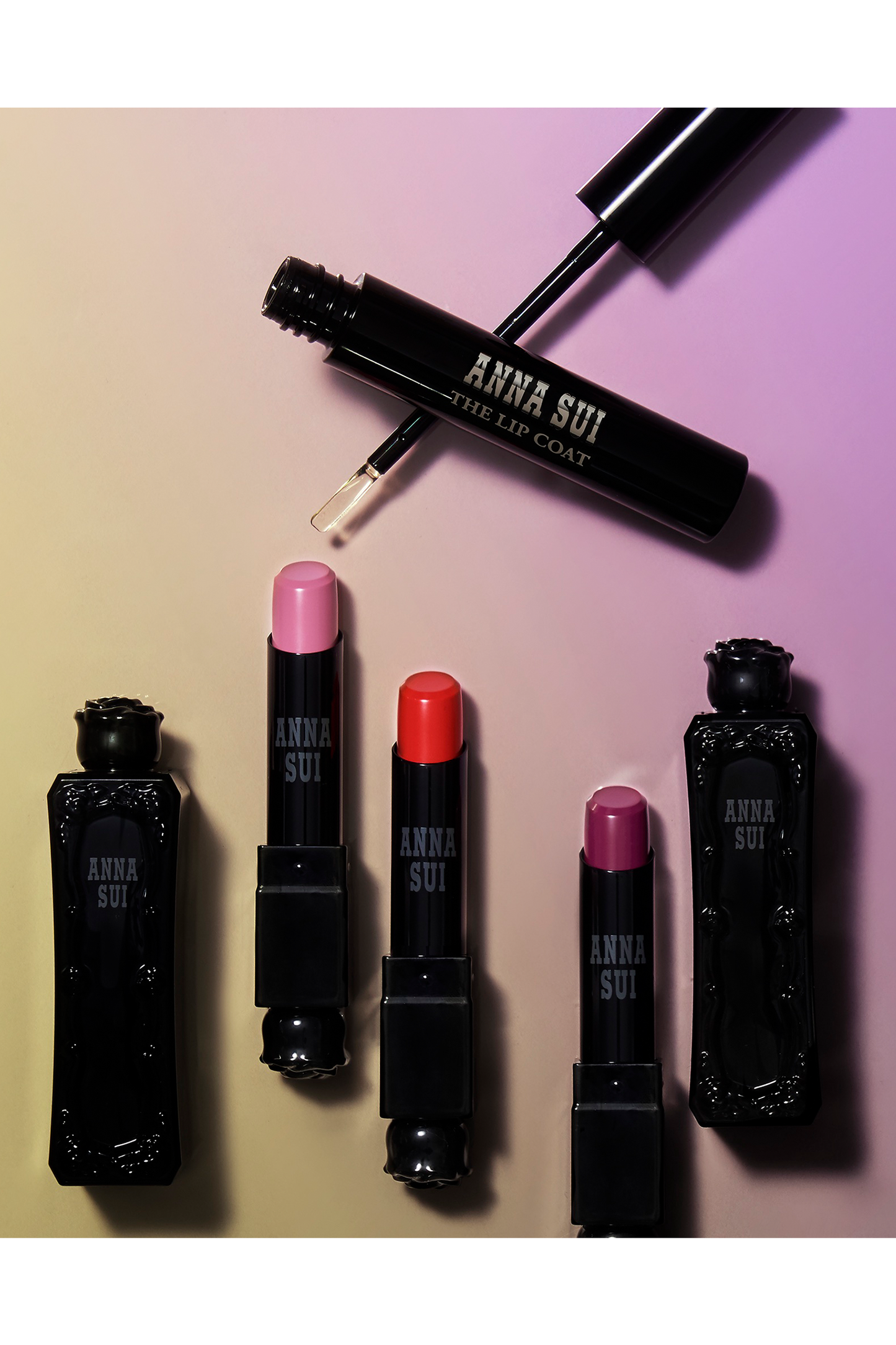 Presentation of Lip coat, in a black cylindrical container, with white label Anna Sui, the Lip Coat 