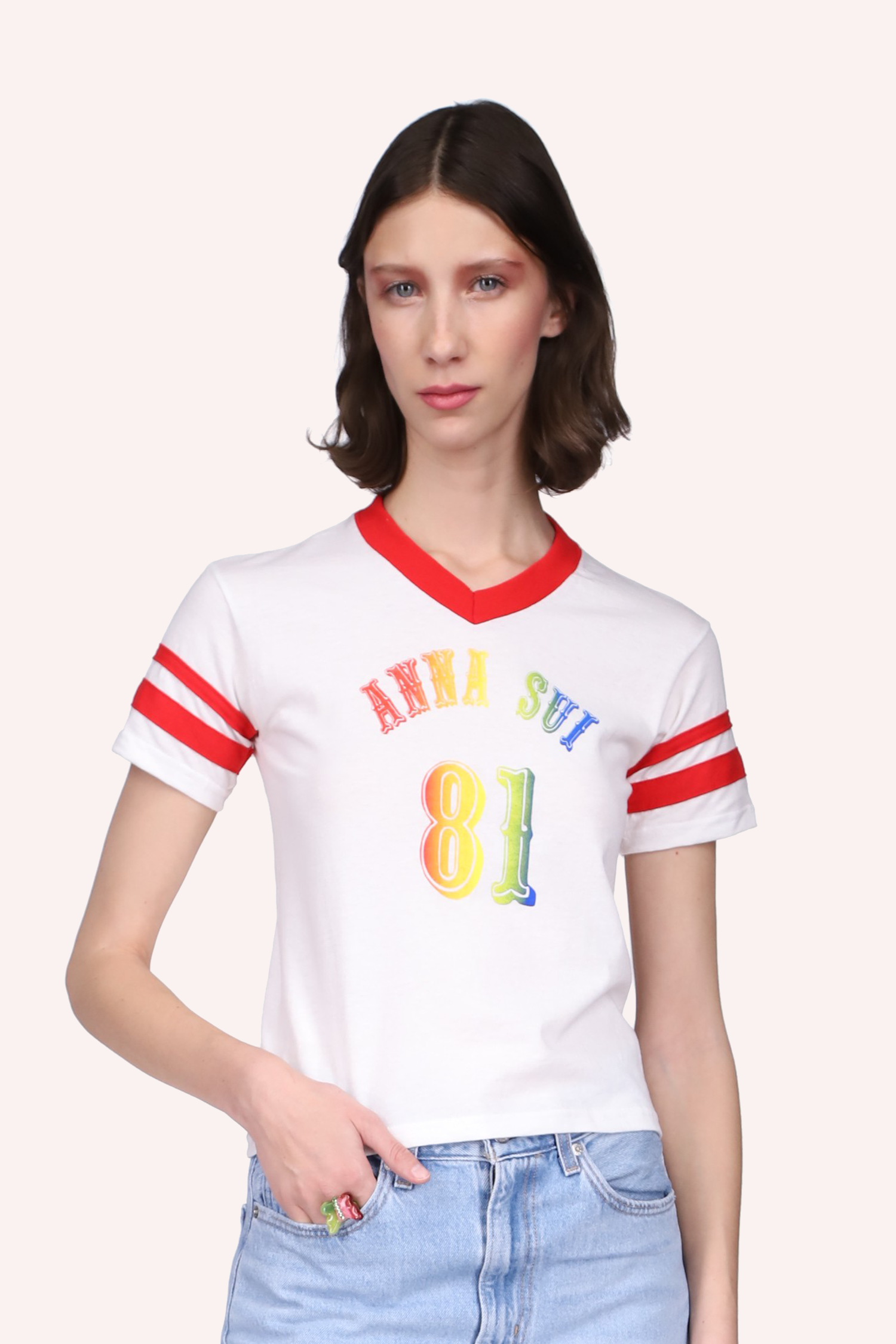 White Tee with short sleeves, a red band on the V-collar, 2 on arms, front print Anna Sui and 81 in rainbow color