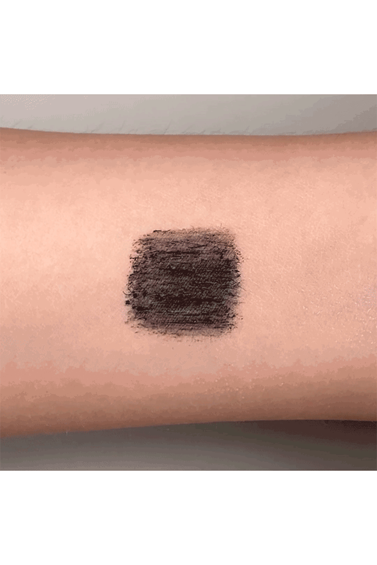 Waterproof Mascara animation, on a forearm with water on it, a finger is trying to remove it